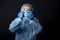 The test tubes are crossed in the doctor`s hands. Girl examines a test tube with biomaterial. Young woman in protective