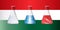 Test tubes with white, red and blue liquid against the background of the flag of Hungarythe background of the flag of Hungary