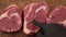 Testing raw ribeye beef steaks on cutting board