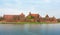 Teutonic castle Malbork in Pomerania region of Poland over Nogat river.