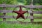 Texas rustic star on countryside side wooden fence, with road to the house slowly dissolving in the background.