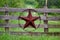 Texas rustic star on countryside side wooden fence, with road to the house slowly dissolving in the background.