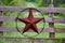 Texas rustic star on countryside side wooden fence, with road to the house slowly dissolving in the background.