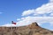 Texas State Flag against Blue Sky with Rock Mesa