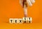 Texas or Texit symbol. Concept word Texas or Texit on beautiful wooden cubes. Beautiful orange table orange background.