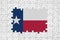 Texas US state flag in frame of white puzzle pieces with missing central part