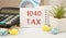 Text 1040-Tax on notepad, calculator