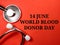 Text 14 june world blood donor day on red background with stethoscope.