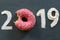 Text 2019, pink donut in glaze