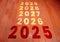 The text 2025 is written on the brick road and the male runner prepares to welcome the new year.