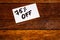 Text 75% off on white label. Label on wooden table, close up