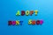 Text adopt don`t shop from plastic colored letters on blue paper background