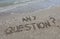 text any question written in the sand of the beach by the sea