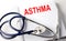 Text ASTHMA on a white background with stethoscope. Medical