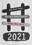 Text on black and white popsicle stick with year 2021background.