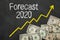 Text on blackboard with money - Forecast 2020