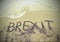 Text BREXIT on the sand of the sea