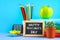 Text chalk on a chalkboard: Happy Teacher\'s Day. School supplies, office, books, apple.