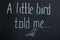 Text on chalkboard `little bird told me` with a picture. Common phrase