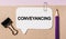 Text Conveyancing on a white sticker with office stationery background. Flat lay on business, finance and development concept
