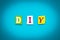 Text - D I Y - from colorful letters on blue background. Single word on banner. Message on poster. Abbreviation - Do It Yourself.