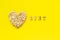 Text Diet and oat flakes in shape heart on yellow background.
