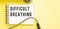 Text DIFFICULT BREATHNG on notebook with stethoscope on yellow background