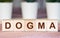 Text of DOGMA on cubes, Word Written In Wooden Cube