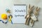 Text Down`s Syndrome, toys, pacifier and awareness ribbons on white textured background