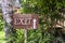 Text exit on a wooden board in a rainforest jungle of tropical Bali island, Indonesia. Exit wooden sign inscription in the asian