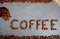 Text from fair trade coffee beans with burlap and spoon at grey kitchen worktop background