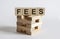 Text FEES on a wooden cube blocks on white background