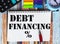Text financial debt on sheet alarm clock, calculator, stickers