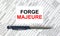 Text Forge Majeure written on a business card lying on financial tables with a blue metal pen