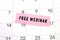 Text Free Webinar written on a pink sticky note posted on a calendar or planner page. Deadline concept read a reminder on calendar