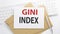 Text GINI INDEX on the envelope on the keyboard