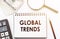 The text global trends on white notebook. Business concept