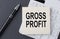 Text GROSS PROFIT on sticker on calculator, business concept