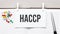 text haccp on stickers on the diary with office tools