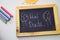 Text hai dude on the chalkboard and colorful chalk,autumn leaf origami. White background