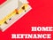 Text HOME REFINANCE with house miniature,