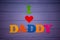 Text `I love daddy` of colorful paper alphabet