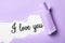 Text I Love You on white background, view through torn purple paper