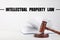 Text Intellectual Property Law over judge`s gavel and book on table