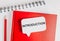 Text Introduction a white sticker on red notepad with office stationery background. Flat lay on business, finance and development