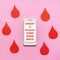 Text JANUARY IS NATIONAL BLOOD DONOR MONTH on smartphone screen with red drops on pink background. Annual national red cross