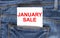 Text January Sale on white paper in the pocket of blue denim jeans