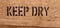 Text Keep dry on wood