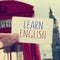 text learn english in a signboard with the Big Ben in the background, with a filter effect