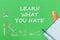 Text learn what you hate, school supplies wooden miniatures, notebook with ruler, pen on green backboard